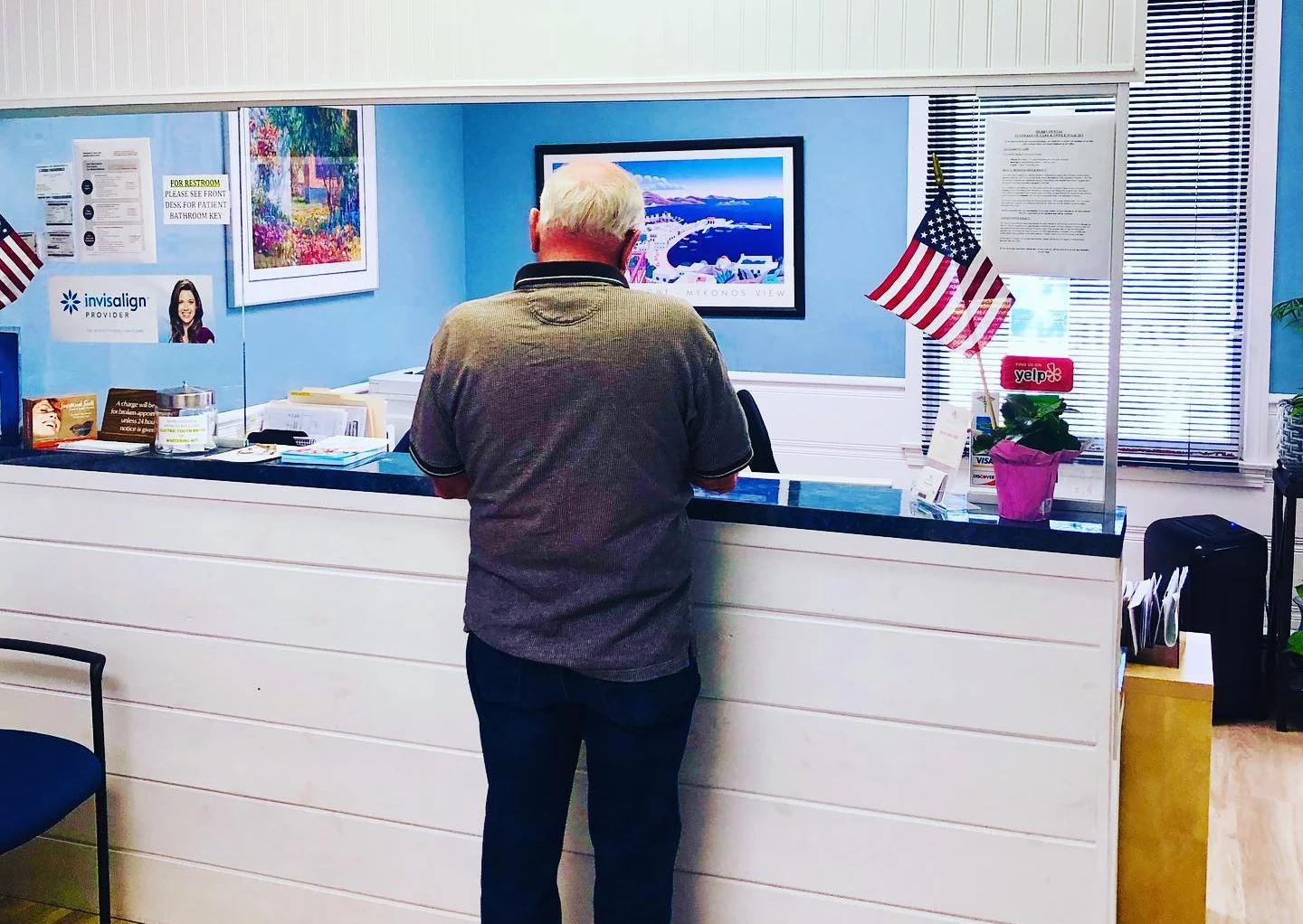 A patient at the Merry Dental front desk