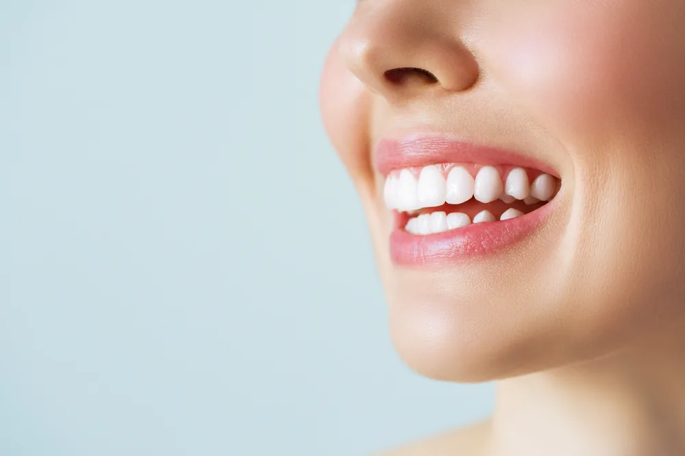 A close-up of a woman's bright white smile